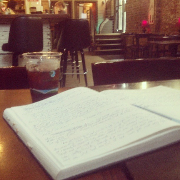 Photo of a notebook and an iced coffee, by Golem Radio